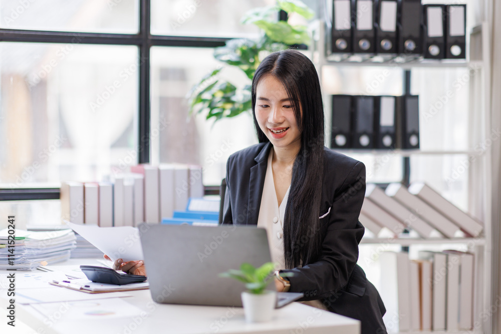 Happy busy young business woman entrepreneur in office using laptop at work, smiling professional asian female company executive manager working looking at computer at workplace. Happy busy young business woman entrepreneur in office using laptop at work, smiling professional asian female company executive manager working looking at computer at workplace.