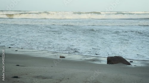 Waves Crashing on the Shore as the Sun Sets Over a Serene Beach in a Tranquil Coastal Area