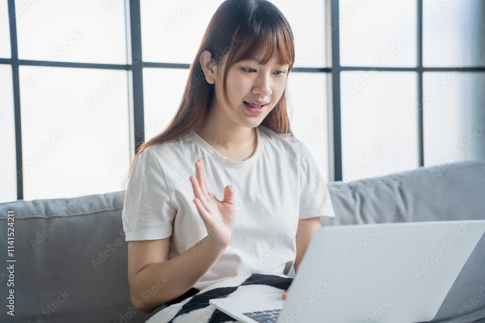 Asian woman video call with family by using laptop Asian woman video call with family by using laptop