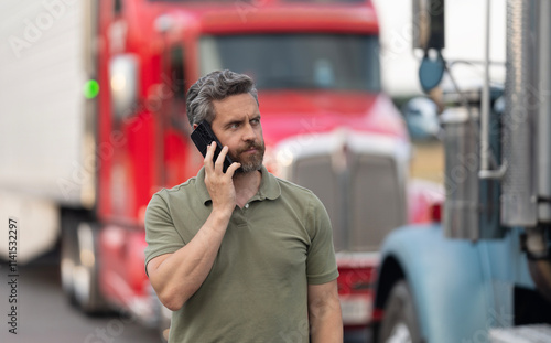 Mature man Hispanic truck driver and owner having phone call outdoor photo