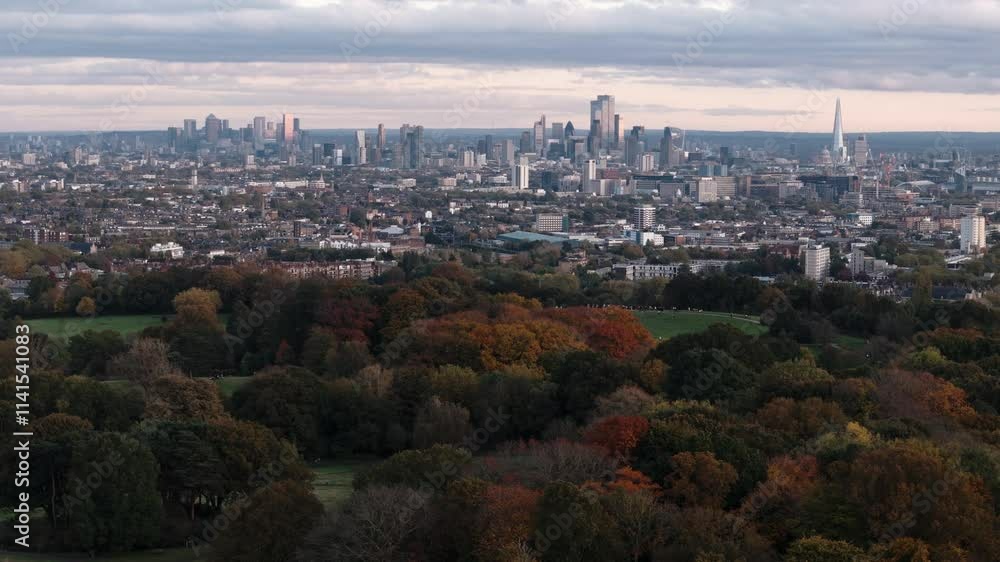 Circling shot of Parliament Hill with vibrant trees and London skyline Circling shot of Parliament Hill with vibrant trees and London skyline