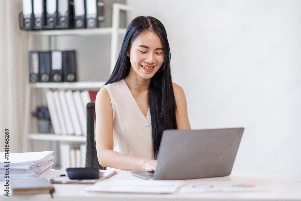 Businessasian woman using laptop computer in office. Happy young woman, entrepreneur, small business owner working online.
Businessasian woman using laptop computer in office. Happy young woman, entrepreneur, small business owner working online.