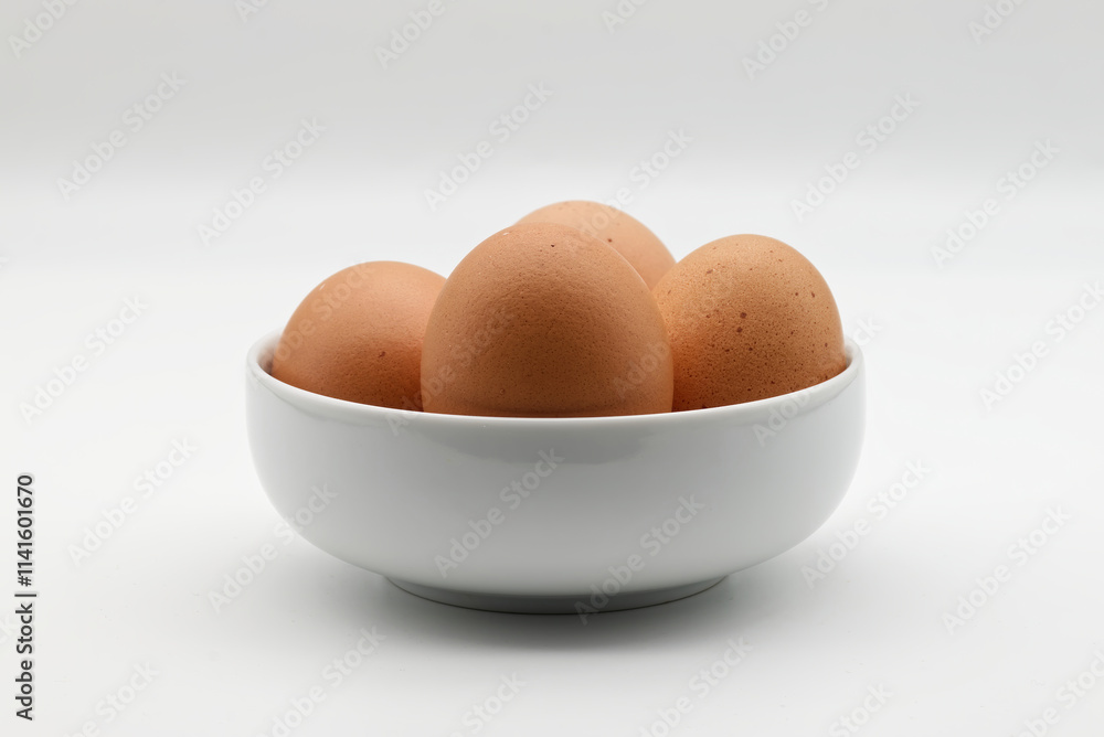 Fresh brown eggs in a white bowl isolated on white background Fresh brown eggs in a white bowl isolated on white background