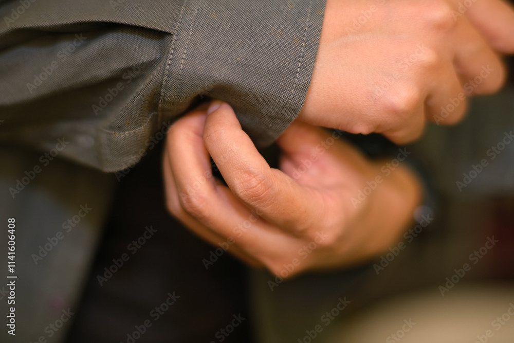 Closeup of a woman hands buttoning a shirt Closeup of a woman hands buttoning a shirt