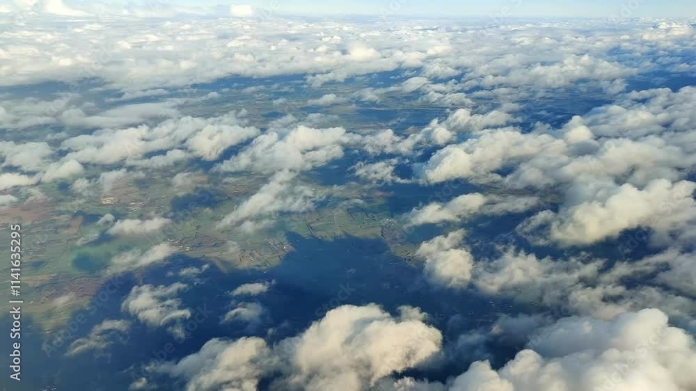Danish farmland with sunlight and shadows from scattered clouds below. Seen from airplane at high altitude Danish farmland with sunlight and shadows from scattered clouds below. Seen from airplane at high altitude