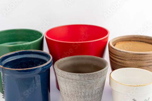 Various sizes and colors of flower pots isolated on a white background. Green, red, brown, blue, gray and white, ceramic empty pots on white background photo