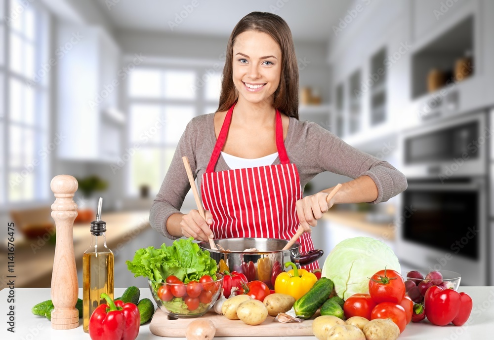 Shot of beautiful young woman cooking food in kitchen Shot of beautiful young woman cooking food in kitchen