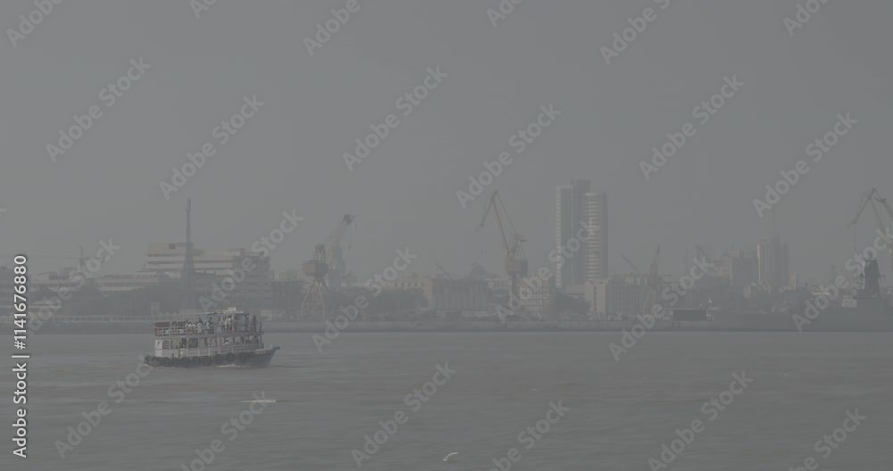 Mumbai, India. Ungraded C LOG 2 Boat with Tourists floating on the Arabian Sea. Tourists boats floating against port background. Many Seagull Flies Behind Boat Mumbai, India. Ungraded C LOG 2 Boat with Tourists floating on the Arabian Sea. Tourists boats floating against port background. Many Seagull Flies Behind Boat