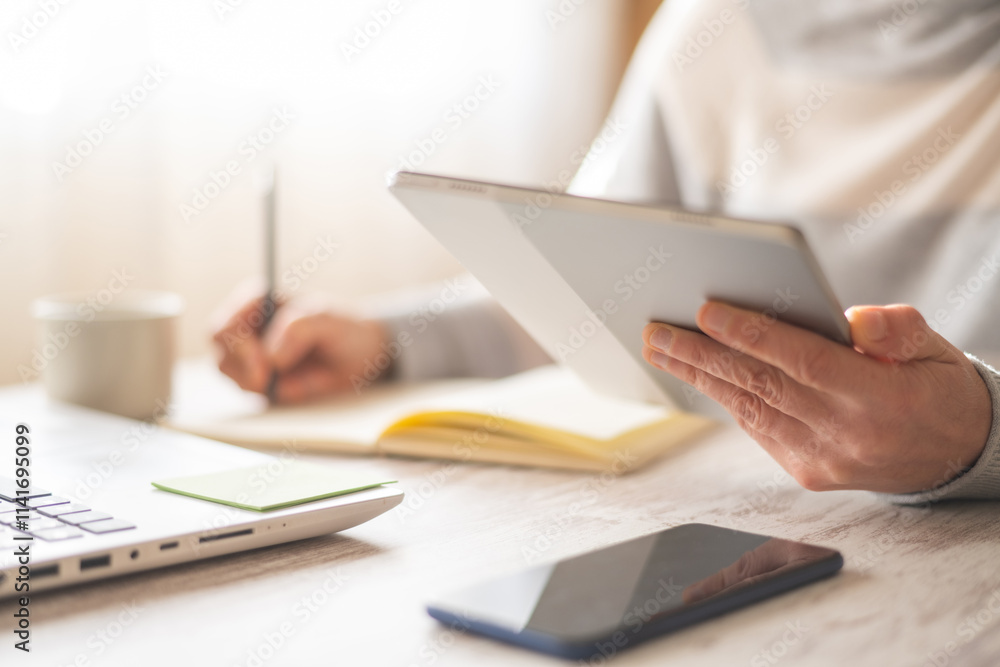 Professional Businesswoman Using Digital Tablet While Working From Home Or Office, Writing Notes,Scheduling Client Appointments, Reviewing Emails,Monitoring Calendar,Observing Data And Managing Tasks Professional Businesswoman Using Digital Tablet While Working From Home Or Office, Writing Notes,Scheduling Client Appointments, Reviewing Emails,Monitoring Calendar,Observing Data And Managing Tasks