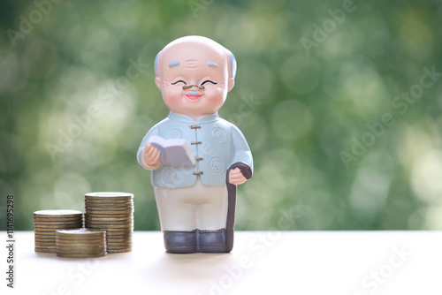 Mutual fund,Seniorman and stack of coins money on natural green background, Save money for prepare in future and pension retirement concept photo