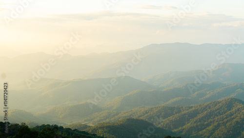 Fototapeta Naklejka Na Ścianę i Meble -  serene landscape showcasing rolling mountains under soft, hazy sky. lush greenery and gentle slopes create tranquil atmosphere, perfect for nature lovers
