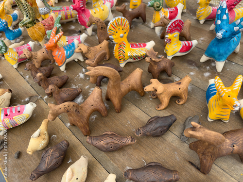 A table full of wooden figurines of various animals photo