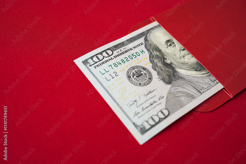 Lucky Asian chinese woman opening a red envelope gift, find large amount of money inside, one hundred united states dollars. Concept for Chinese New Year. Lucky Asian chinese woman opening a red envelope gift, find large amount of money inside, one hundred united states dollars. Concept for Chinese New Year.