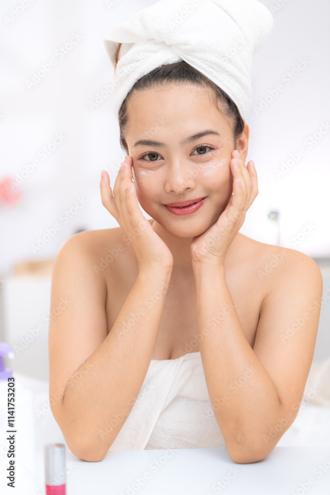 Asian young woman with towel wrapped on head and body applying makeup after shower, Morning beauty routine before work Asian young woman with towel wrapped on head and body applying makeup after shower, Morning beauty routine before work