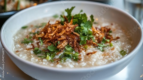 Creamy Rice Porridge Topped with Crispy Onions and Fresh Herbs