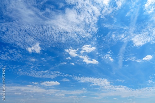 This captivating blue sky features fluffy white clouds scattered across a bright sunny day, creating a picturesque scene for nature lovers and outdoor enthusiasts.