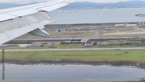 Plane landing at Osaka Kansai International Airport airplane wing window view 4k footage