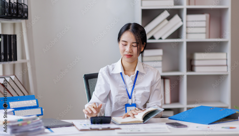 Asian woman hand using calculator to calculate doing finance, budgeting and tax calculation. finance, accounting with laptop computer on table, budget management, monthly expenses
