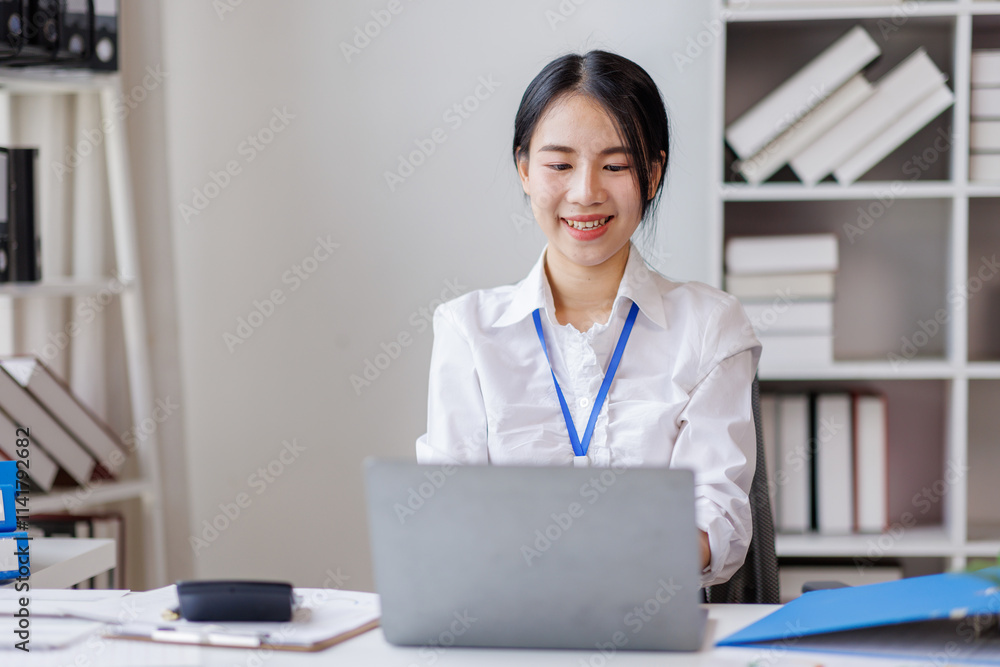 Business asian woman work on laptop sitting at desk in bright office, working and smiling Financial and Accounting concept. Business asian woman work on laptop sitting at desk in bright office, working and smiling Financial and Accounting concept.