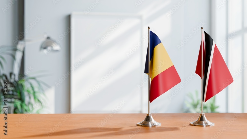 FLAGS OF ROMANIA AND TRINIDAD ON TABLE FLAGS OF ROMANIA AND TRINIDAD ON TABLE
