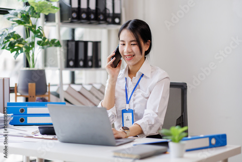 Wallpaper Mural Asian woman entrepreneur busy with her work in the office. Young Asian woman work on desk laptop phone while planning sales, research or financial strategy in company
 Torontodigital.ca