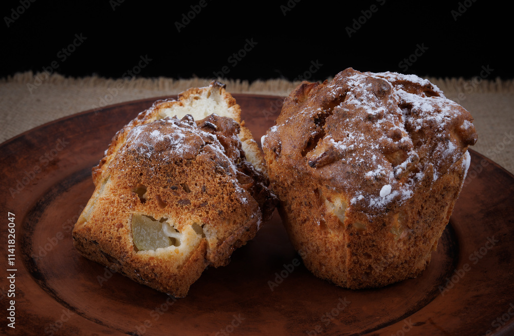 Cut muffin on a clay plate. Fresh delicious muffin. Cut muffin on a clay plate. Fresh delicious muffin.