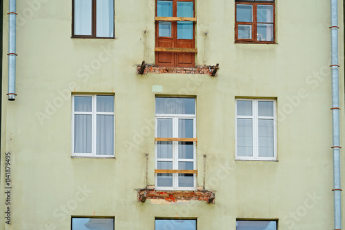 Balcony renovation of historic building, reinforcement of building. Restoration, repair work. Structural repair, concrete reinforcement of historic building facade. Balcony installation, renovation