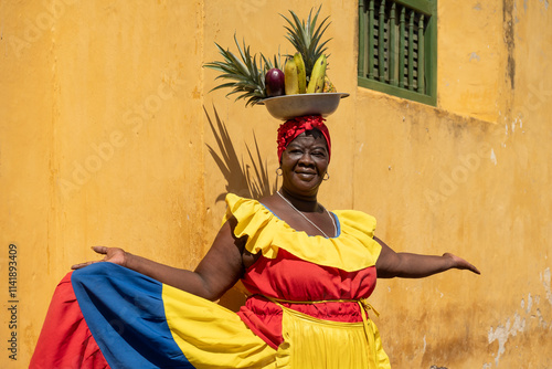 Woman Wearing A Colorful Traditional Colombian Dress Balancing Fruits On Her Head