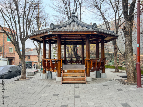 A wooden pavilion structure offering a peaceful resting spot, blending harmoniously with its natural surroundings. photo