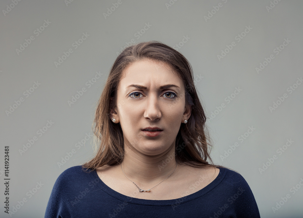 Young woman showing disgust and looking at camera Young woman showing disgust and looking at camera