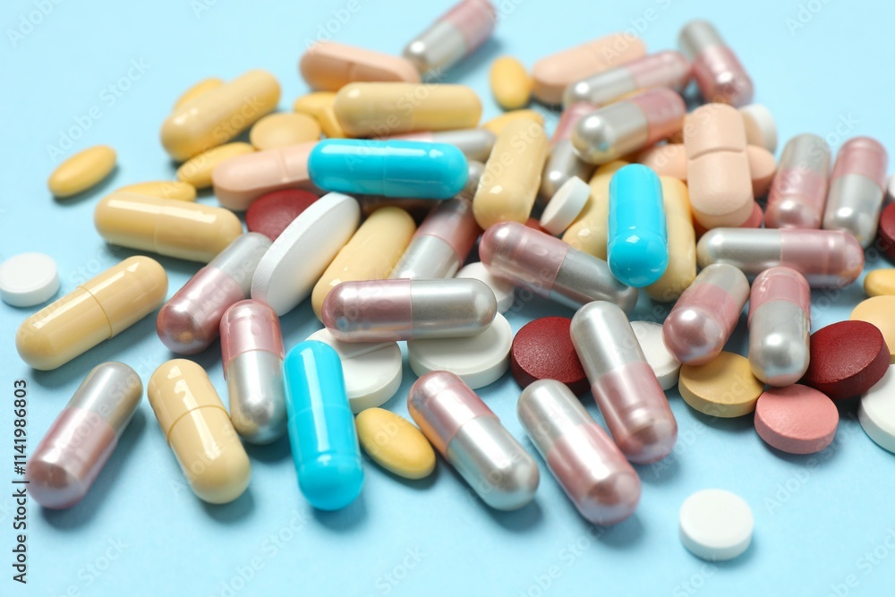 Various tablets and capsules on a colored background Various tablets and capsules on a colored background