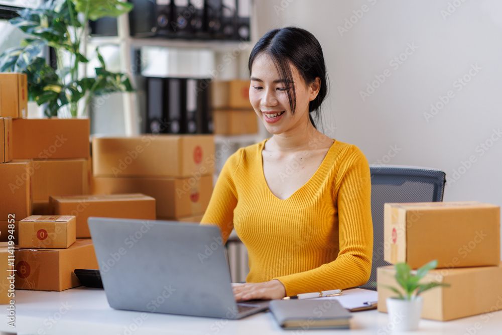 Happy young asian woman SME startup small business freelance work on parcel box and laptop computer , Online marketing packing box delivery SME e-commerce concept Happy young asian woman SME startup small business freelance work on parcel box and laptop computer , Online marketing packing box delivery SME e-commerce concept