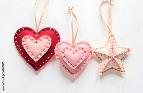 Three handcrafted felt ornaments, two hearts and one star, featuring layered stitching and soft tones perfect for Valentine's Day, home decor, or gift ideas. Selective focus