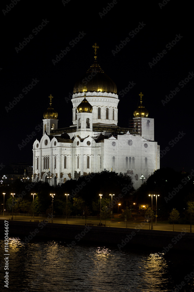 The Cathedral of Christ the Savior, the largest church in Russia, burns brightly in the dark night. Moscow. Russia. The Cathedral of Christ the Savior, the largest church in Russia, burns brightly in the dark night. Moscow. Russia.
