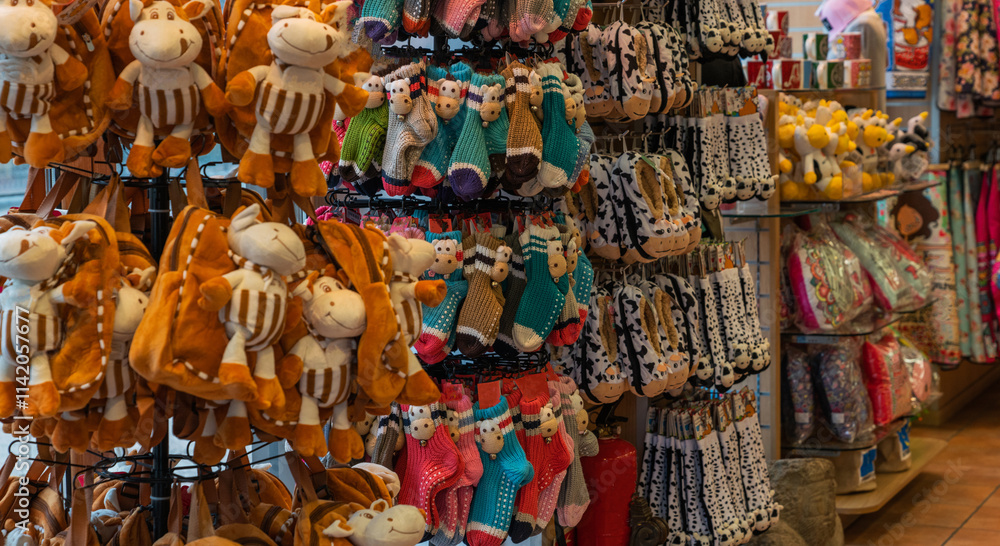 a vibrant selection of stuffed toys and colorful hand-knitted socks on display in a cozy gift shop, creating a cheerful and inviting atmosphere for shoppers a vibrant selection of stuffed toys and colorful hand-knitted socks on display in a cozy gift shop, creating a cheerful and inviting atmosphere for shoppers