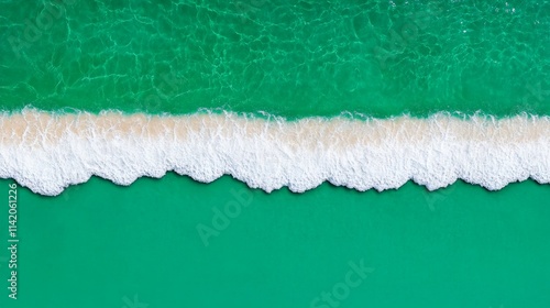 Turquoise Waters and Foamy Waves: An aerial perspective captures the serene beauty of turquoise water meeting a line of foamy white waves, creating a captivating abstract pattern of nature's artistry. photo