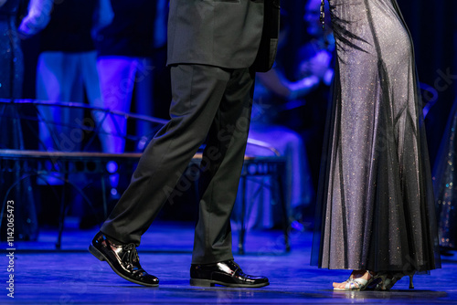 Closeup of legs dancing waltz on theatre stage photo