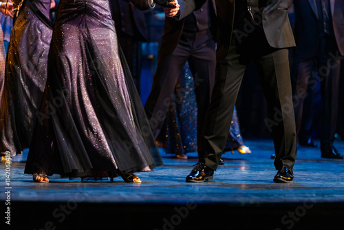 Closeup of legs dancing waltz on theatre stage photo