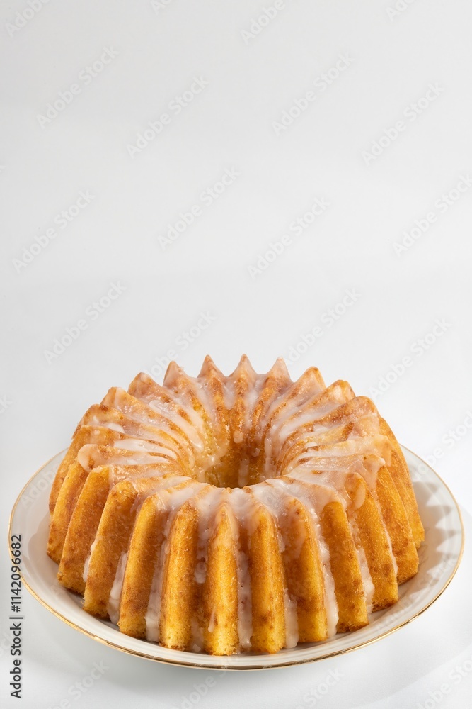 Glazed sponge cake on an old plate and a white background Glazed sponge cake on an old plate and a white background