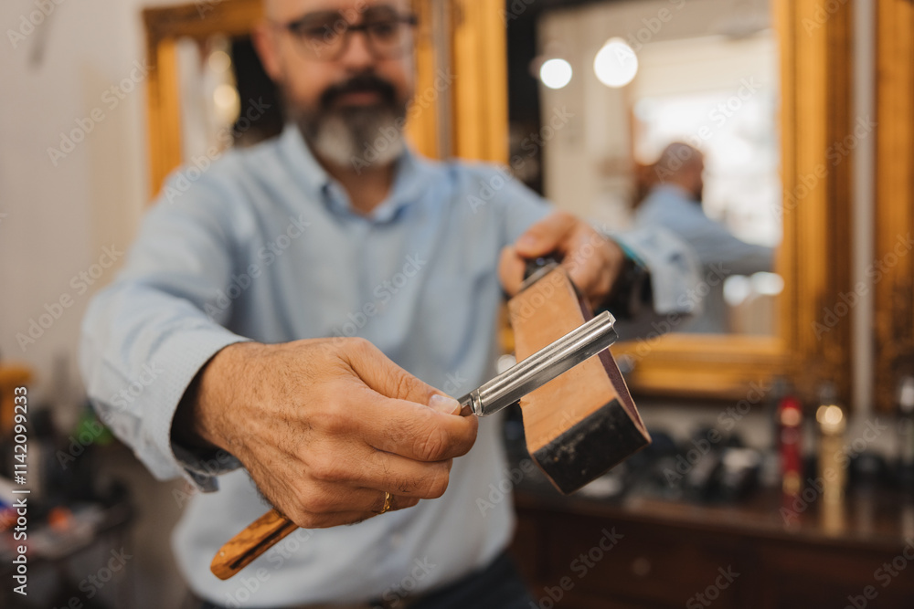 A man is shaving with a razor A man is shaving with a razor