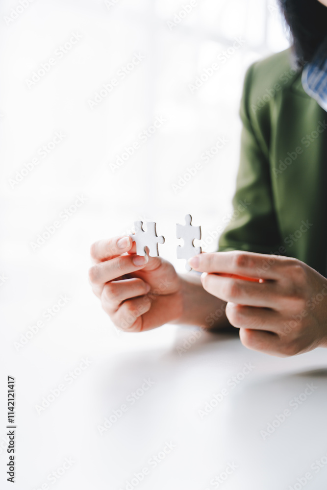 Close-up of business hands connecting with jigsaw puzzle achievements and goals Business concept, strategic planning as a team Close-up of business hands connecting with jigsaw puzzle achievements and goals Business concept, strategic planning as a team