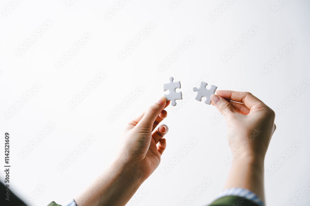Close-up of business hands connecting with jigsaw puzzle achievements and goals Business concept, strategic planning as a team Close-up of business hands connecting with jigsaw puzzle achievements and goals Business concept, strategic planning as a team
