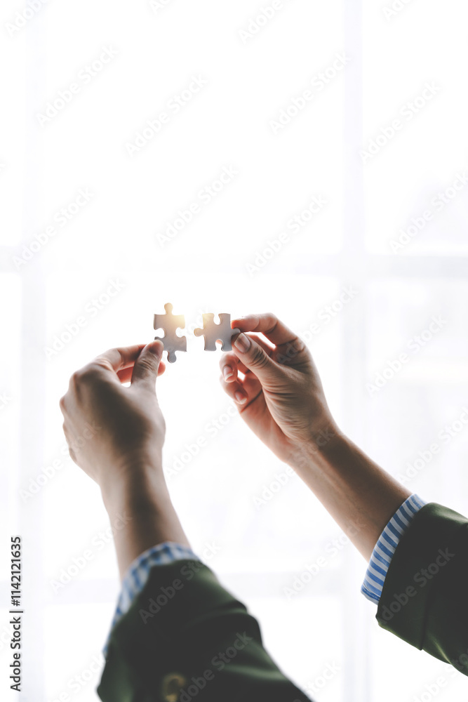 Close-up of business hands connecting with jigsaw puzzle achievements and goals Business concept, strategic planning as a team