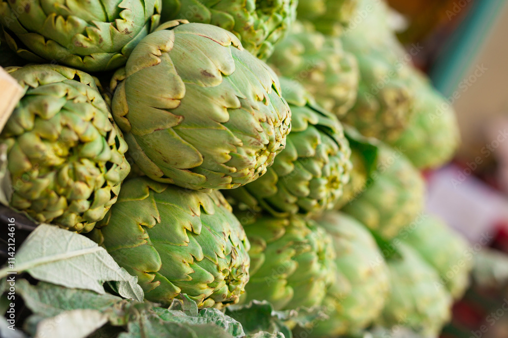 Fresh artichokes on market counter Fresh artichokes on market counter