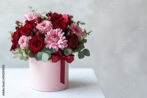 Elegant Bouquet of Red and Pink Flowers in a Gift Box on White Table