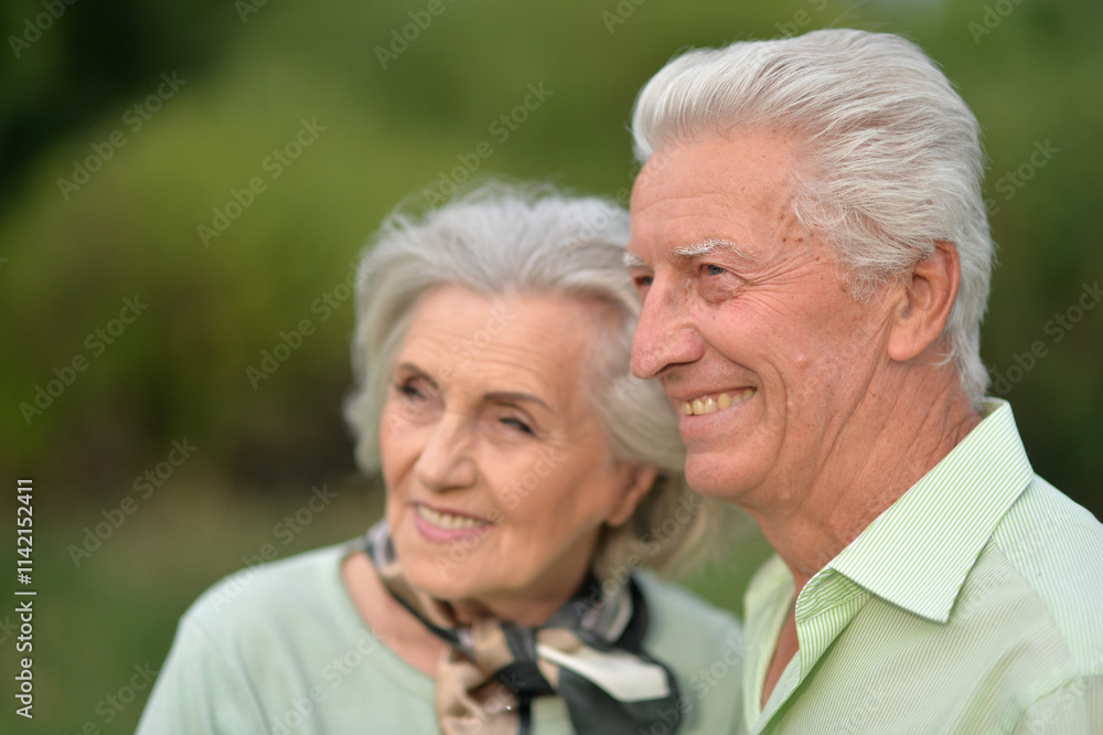 Loving mature couple in the park in summer Loving mature couple in the park in summer