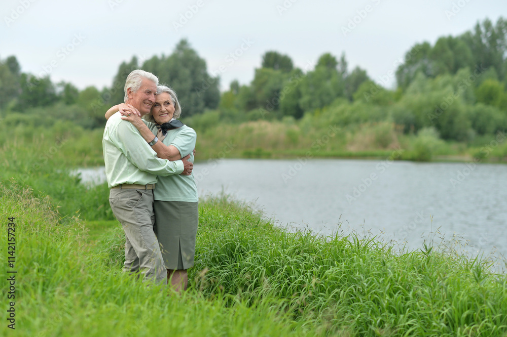 Loving mature couple in the park in summer Loving mature couple in the park in summer