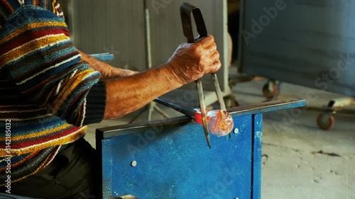 A master glassmaker is seen crafting a beautiful crystal vase out of the finest Murano glass in the island of Murano, Venice, Italy. Venice is an archipelago of 126 islands linked by 472 bridges