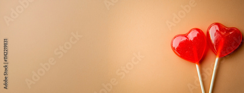 Beige background with two red heart lollipops, free space for text