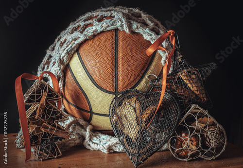 Obraz na płótnie Basketball ball inside of mesh net string decoration with Christmas tree mesh case, Heart mesh case, Star mesh case on Dark background. Christmas-themed event basketball idea, Sports play on christmas w salonie